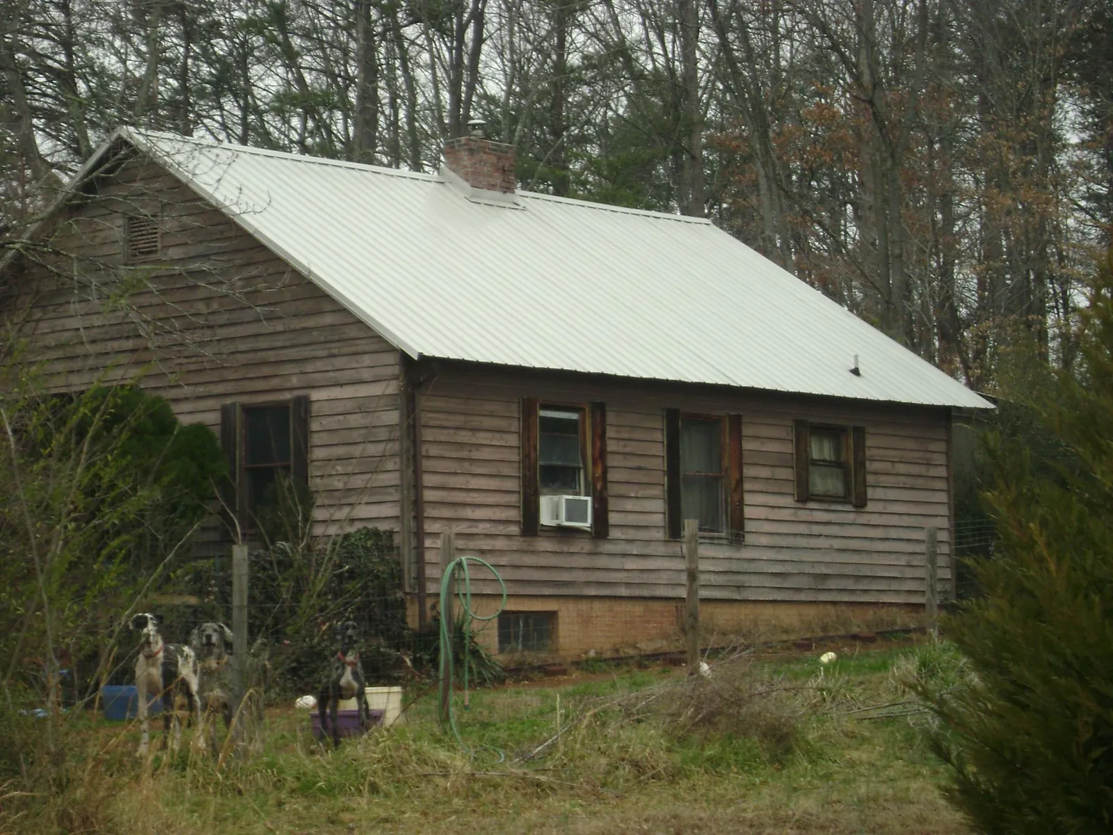 White metal roof on an old wood sided farmhouse, from a Metal Roof Installation job in Vernal
